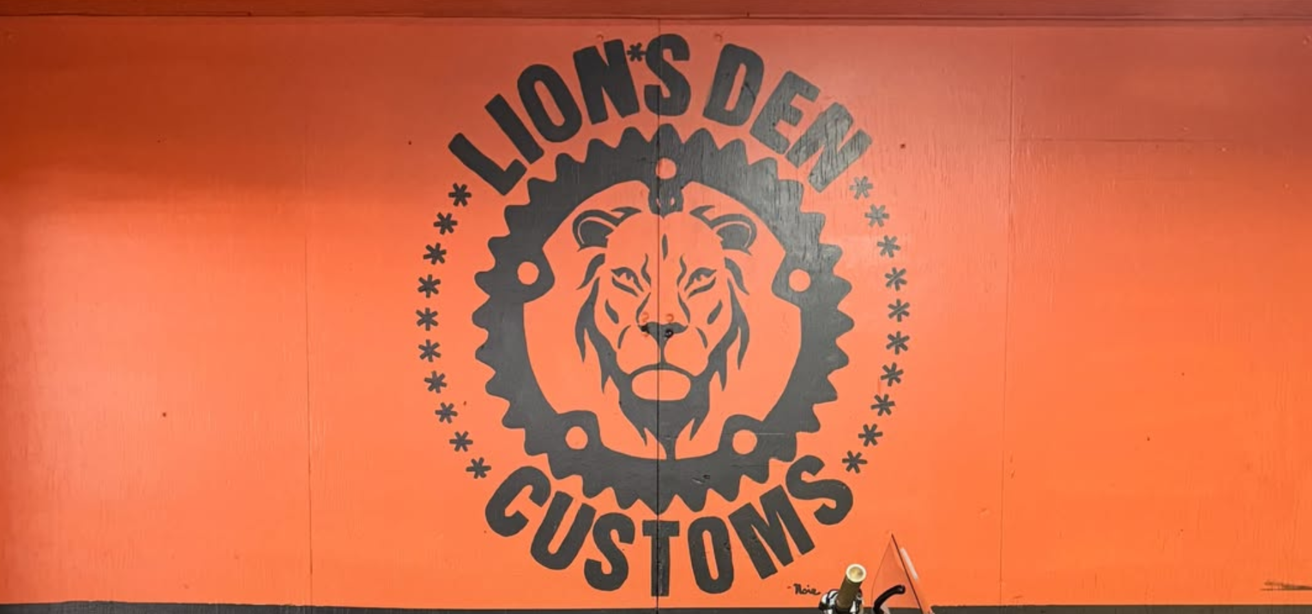Orange Lion's Den Customs shop wall mural